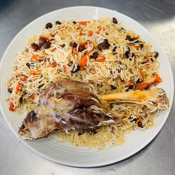 Afghan Kabob House's Qabuli Palaw, a lamb shank on a bed of rice with carrots and raisins.
